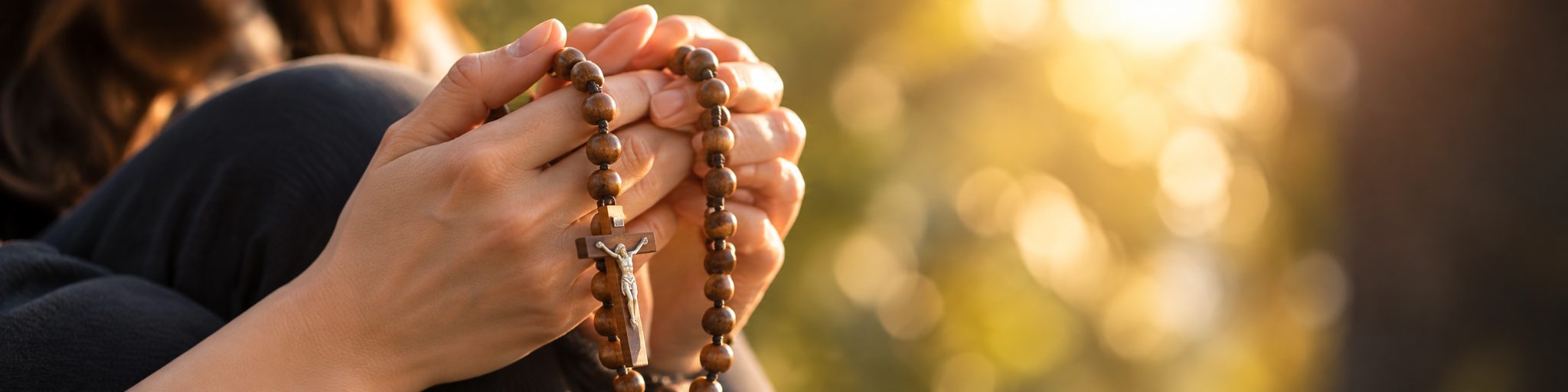 Hands holding rosary beads