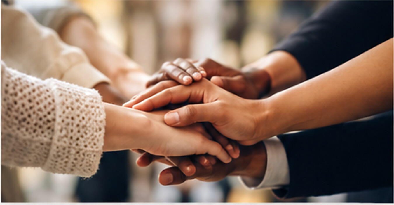 People placing their hands together as a sign of teamwork and community